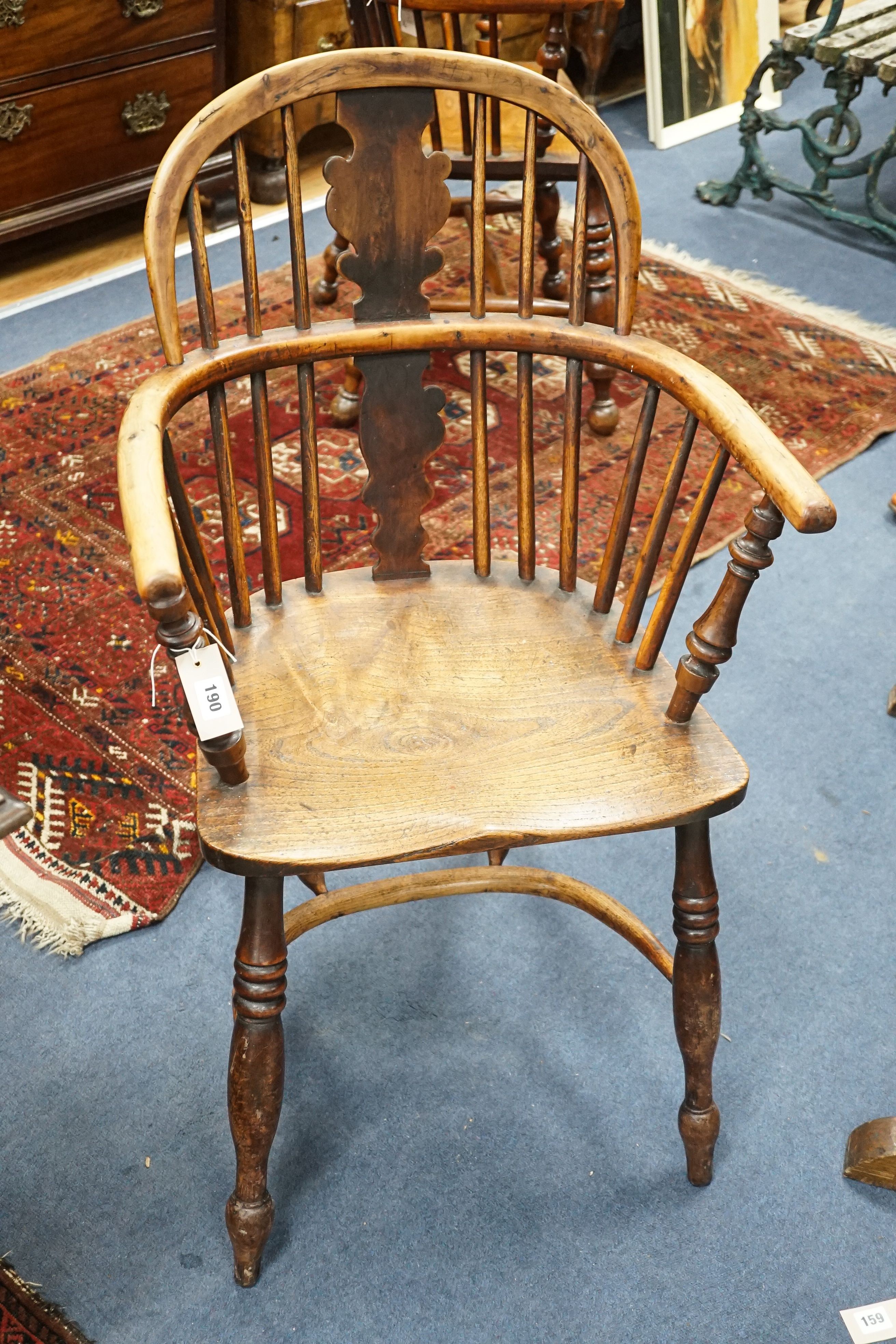 A 19th century yew and elm Windsor elbow chair with blind splat and crinoline stretcher, width 55cm, depth 40cm, height 93cm